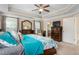 Comfortable main bedroom featuring large windows, a ceiling fan, and ample closet space at 114 Bell Tower Ct, Elon, NC 27244