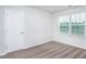Bright bedroom with neutral carpet, featuring a window and a door at 11412 International Dr, Middlesex, NC 27557