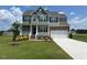 Traditional two-story home with stone accents, attached garage, and a well-manicured lawn at 11412 International Dr, Middlesex, NC 27557