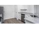 Modern kitchen featuring granite countertops, stainless steel appliances, and hardwood flooring at 11412 International Dr, Middlesex, NC 27557