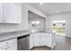 Bright kitchen featuring stainless steel appliances, white cabinetry and granite countertops at 11412 International Dr, Middlesex, NC 27557
