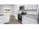 Well-equipped kitchen featuring stainless steel appliances, ample storage, and granite counters at 11412 International Dr, Middlesex, NC 27557