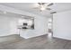 Bright living room with luxury vinyl flooring leading to a kitchen with granite countertops and stainless appliances at 11412 International Dr, Middlesex, NC 27557