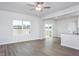 Open-concept living area with luxury vinyl flooring, deck access, and adjacent kitchen space for entertaining at 11412 International Dr, Middlesex, NC 27557