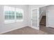 Bright home office with a large window, a glass door, and neutral carpet, perfect for productivity at 11412 International Dr, Middlesex, NC 27557