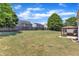 Large fenced backyard featuring a patio, a fire pit, and green grass at 120 Cobblebrook Ct, Holly Springs, NC 27540