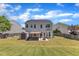 A well-maintained backyard with a covered patio, a fire pit, and lots of green space at 120 Cobblebrook Ct, Holly Springs, NC 27540
