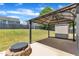 Relax in this backyard oasis featuring a covered patio and fire pit with seating area at 120 Cobblebrook Ct, Holly Springs, NC 27540