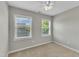 Cozy bedroom filled with natural light from two windows and featuring a ceiling fan at 120 Cobblebrook Ct, Holly Springs, NC 27540