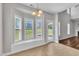 A sunlit dining area featuring a window seat, a chandelier, and a back door, perfect for enjoying meals at 120 Cobblebrook Ct, Holly Springs, NC 27540