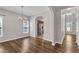 Bright dining room with wood floors, chandelier, and archway, creating an inviting atmosphere at 120 Cobblebrook Ct, Holly Springs, NC 27540