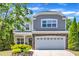 Charming two-story home features a stone facade and well-manicured landscaping, enhancing curb appeal at 120 Cobblebrook Ct, Holly Springs, NC 27540