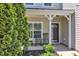 Inviting front porch features rocking chairs and a well-maintained garden, offering a cozy outdoor space at 120 Cobblebrook Ct, Holly Springs, NC 27540