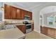 A well-equipped kitchen with stainless steel appliances, complemented by warm cabinets and access to the home's entryway at 120 Cobblebrook Ct, Holly Springs, NC 27540