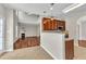The kitchen opens to the living room. This inviting space showcases beautiful hardwood floors and a cozy fireplace at 120 Cobblebrook Ct, Holly Springs, NC 27540
