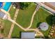 Aerial view of the backyard featuring a gazebo, pool, brick walkway, and mature landscaping at 1213 Indian Trail Dr, Raleigh, NC 27609
