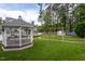 Expansive backyard featuring a charming gazebo, a swing set, an above-ground pool, and lush greenery at 1213 Indian Trail Dr, Raleigh, NC 27609