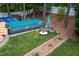 Backyard view showcasing an above ground pool, outdoor seating, and landscaping, perfect for summer relaxation at 1213 Indian Trail Dr, Raleigh, NC 27609