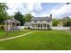 Backyard view of large gazebo, screened in porch, large lawn and lush trees at 1213 Indian Trail Dr, Raleigh, NC 27609