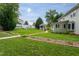 A serene backyard featuring a gazebo, swing set, mature trees, and well-maintained lawn and landscape at 1213 Indian Trail Dr, Raleigh, NC 27609
