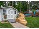 Backyard with a shed, pool, patio, and lush landscaping creates a private outdoor oasis at 1213 Indian Trail Dr, Raleigh, NC 27609