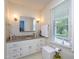 Bathroom featuring granite counters, cabinetry, and a window for natural light at 1213 Indian Trail Dr, Raleigh, NC 27609