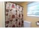 Bathroom showcasing a decorative shower curtain, vanity, and white linen hamper at 1213 Indian Trail Dr, Raleigh, NC 27609