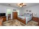 Bright bedroom with hardwood floors, a comfortable bed, and natural light from the window at 1213 Indian Trail Dr, Raleigh, NC 27609