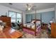 Bedroom with carpeted floor, four-poster bed, and a ceiling fan at 1213 Indian Trail Dr, Raleigh, NC 27609
