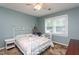 Bedroom with a metal bed frame, carpet flooring, natural light from the window, and side table at 1213 Indian Trail Dr, Raleigh, NC 27609