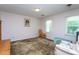 Bright bedroom with pale pink walls, neutral carpet, and large window allowing natural light at 1213 Indian Trail Dr, Raleigh, NC 27609