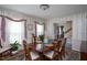 Formal dining room with wooden table and seating, with entry to staircase and other rooms at 1213 Indian Trail Dr, Raleigh, NC 27609