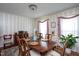 Traditional dining room with wood table, chairs, vintage wallpaper, and natural light at 1213 Indian Trail Dr, Raleigh, NC 27609