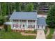 Aerial view of a charming two-story home with mature trees, pristine landscaping, and inviting curb appeal at 1213 Indian Trail Dr, Raleigh, NC 27609