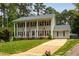 Inviting two-story home with a well-manicured lawn, mature trees, and a welcoming entrance at 1213 Indian Trail Dr, Raleigh, NC 27609