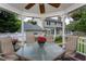 Interior view of gazebo showing table, chairs, fan, wind chimes and hanging plant decor at 1213 Indian Trail Dr, Raleigh, NC 27609