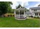 View of the backyard featuring a beautiful gazebo with seating and manicured landscaping at 1213 Indian Trail Dr, Raleigh, NC 27609