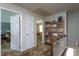 Upstairs hallway with carpet, access to attic, and a bookcase at 1213 Indian Trail Dr, Raleigh, NC 27609