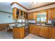 Traditional kitchen featuring oak cabinets, stainless steel appliances, and a tile floor at 1213 Indian Trail Dr, Raleigh, NC 27609