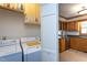 A compact laundry room adjacent to the kitchen, equipped with modern washer and dryer at 1213 Indian Trail Dr, Raleigh, NC 27609