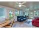 Bright sunroom with ample seating, tile floor, and access to the backyard at 1213 Indian Trail Dr, Raleigh, NC 27609