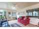 Sunroom with comfortable seating, a ceiling fan, and a view of the yard and landscaping at 1213 Indian Trail Dr, Raleigh, NC 27609
