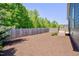 Backyard with privacy fence, wood chips, and trees at , Chapel Hill, NC 27516
