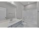 Bathroom with a sleek vanity and a shower-tub combination featuring white-tiled walls at 127 Post Oak Rd, Chapel Hill, NC 27516