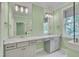Luxurious bathroom with a double vanity, marble countertops, and a window for natural light at 127 Post Oak Rd, Chapel Hill, NC 27516
