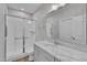 Bathroom with a sleek marble vanity and a glass-enclosed shower featuring white-tiled walls at 127 Post Oak Rd, Chapel Hill, NC 27516