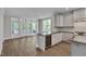 The kitchen features stainless appliances, gray cabinets, and a wine cooler, opening up to a dining area at , Chapel Hill, NC 27516