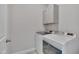 Practical laundry room features modern washer and dryer with upper cabinets at , Chapel Hill, NC 27516