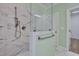 Walk-in shower featuring white marble tiling and a frameless glass enclosure at 127 Post Oak Rd, Chapel Hill, NC 27516