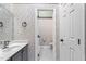 Powder room featuring wallpaper, a modern vanity, and an entry to another bathroom at 140 Heatherwood Dr, Apex, NC 27502